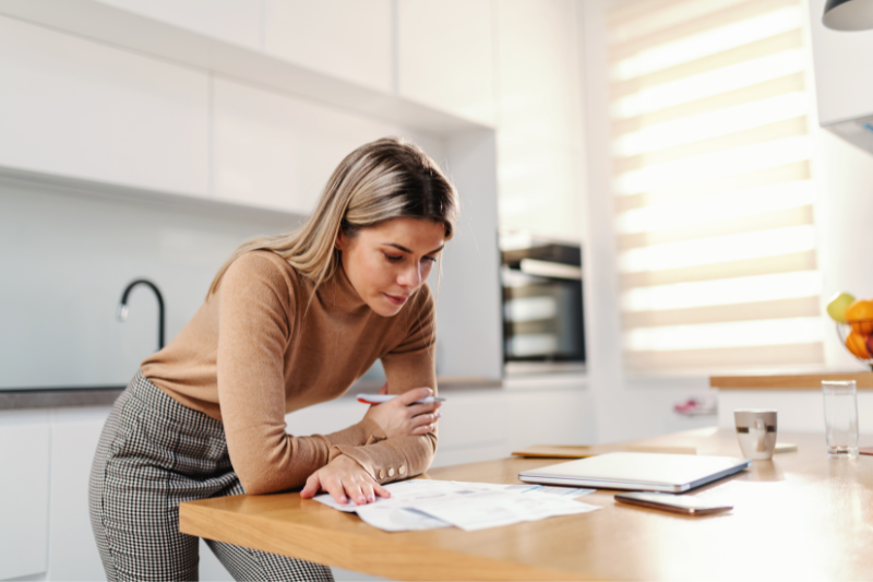 Woman analyzing loan documents, Mortgage Broker, Mortgage Lender, Mortgage Rates, First Time Home Buyer